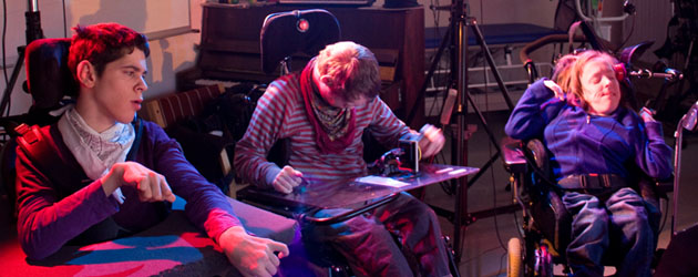 Three musicians in wheelchairs playing using switches